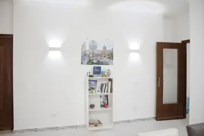 a room with two lights and a book shelf at B&B d'Orleans in Palermo