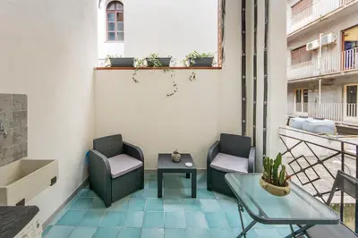 a balcony with two chairs and a table on a building at Casa Valire in Palermo