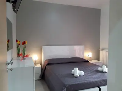 a bedroom with a bed with two stuffed animals on it at Appartamento 