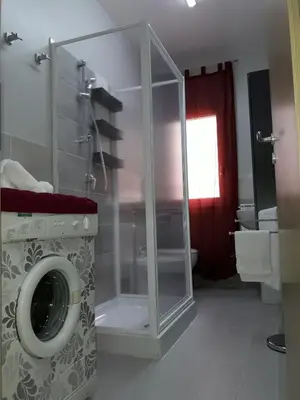 a bathroom with a washing machine in a room at Appartamento 
