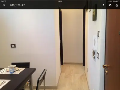 a dining room with a table and a white wall at Giù a Palermo in Palermo