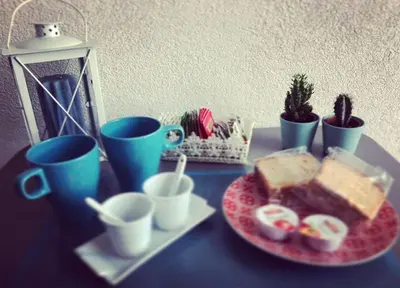 a table with a plate of bread and coffee cups at Il Sole di Mondello in Mondello