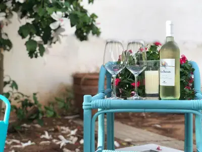 a table with two glasses and a bottle of wine at Il Sole di Mondello in Mondello