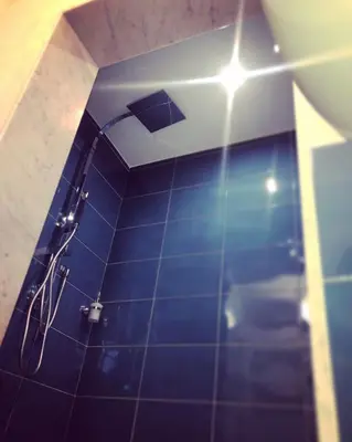 a bathroom with a shower with a light on the ceiling at Il Sole di Mondello in Mondello