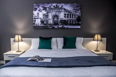 a bedroom with a large bed with a book on it at Amarillo in Palermo