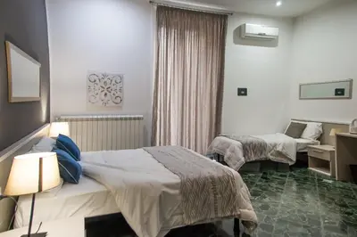 a hotel room with two beds and a desk at Amarillo in Palermo