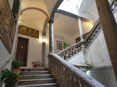 a spiral staircase in a building with a stair case at Casa in palazzo Graffeo Sven in Palermo