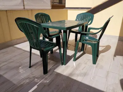 a green table and two chairs sitting next to a table at CASA VACANZE DEL GOLFO 2 in Castellammare del Golfo