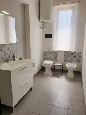 a bathroom with a shower with a tiled wall at Villa Flore in Casteldaccia