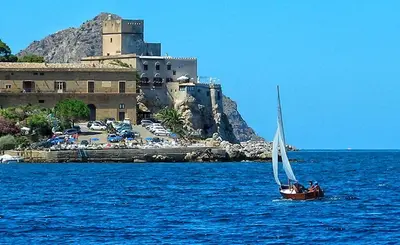 a boat in the water under a cloudy sky at Villa Flore in Casteldaccia