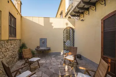a patio with chairs and a fountain in a building at Casa al Bragone in Termini Imerese