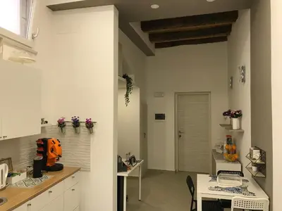 a kitchen with white cabinets and a table at centruMassimo b&b in Palermo