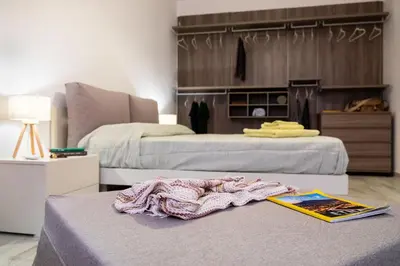 a bedroom with two beds and a book on a table at Vasa Vasa Home in Palermo