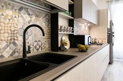 a kitchen with a black sink and a counter at Vasa Vasa Home in Palermo