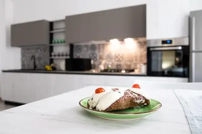 a plate of food on a table in a kitchen at Vasa Vasa Home in Palermo