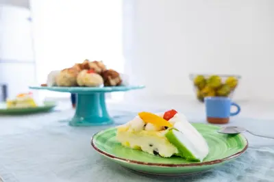 a green plate of food on a table at Vasa Vasa Home in Palermo
