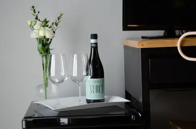 a bottle of wine and two wine glasses on a table at B&B AL PASSIO in Palermo