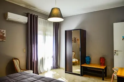 a bedroom with a mirror and a bed and a window at B&B AL PASSIO in Palermo