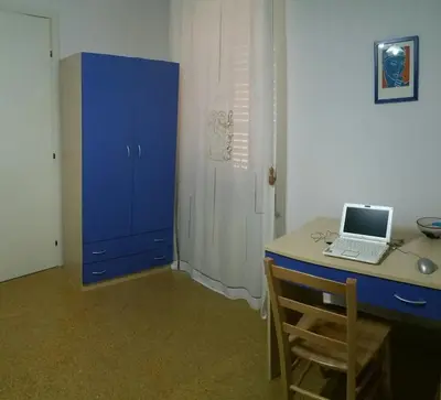 a blue desk with a laptop on a blue cabinet at Benvenuti al Massimo in Palermo