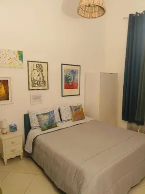 a bedroom with a blue bed in a room at B&B IL POETA in Palermo