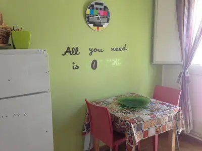 a dining room table with a table and a clock on the wall at Stardust Home in Palermo