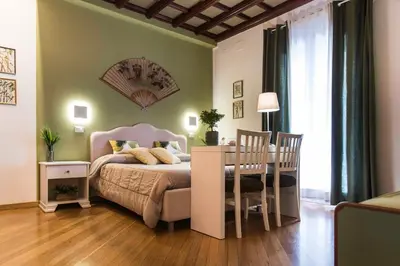 a bedroom with a bed and a table and chairs at Tetide Home in Palermo