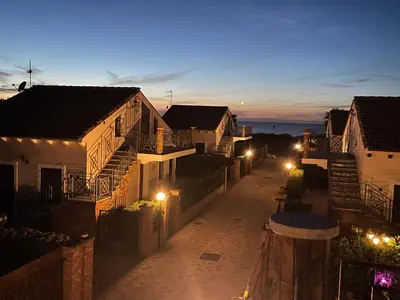 a city street with houses at night with lights at MARE AZZURRO in Campofelice di Roccella