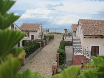 a view of a street with houses and the ocean at MARE AZZURRO in Campofelice di Roccella