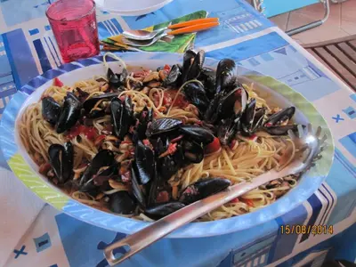 a bowl of pasta with mussels on a table at MARE AZZURRO in Campofelice di Roccella