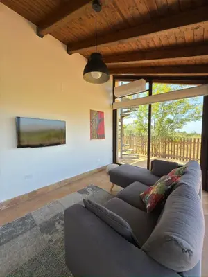 a living room with a couch and a tv at Azienda Agrituristica Baglio Carta in Balestrate