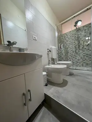 a bathroom with a sink and a toilet and a shower at Rua House in Corleone
