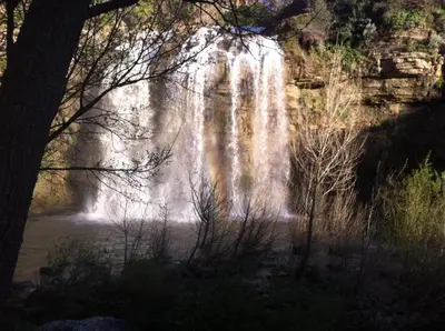 a waterfall in the middle of a river at Rua House in Corleone