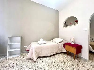 a bedroom with a bed with a table and a mirror at Rua House in Corleone