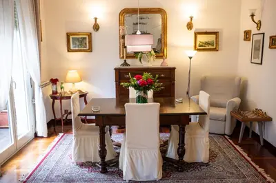 a dining room with a table with flowers on it at Scirocco House in Palermo