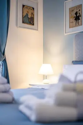 a bedroom with a bed and a lamp at Scirocco House in Palermo