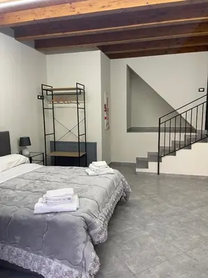 a bedroom with a bed and a staircase in it at B&B Antichi Cortili in Termini Imerese