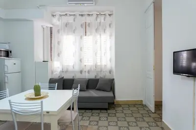 a living room with a couch and a table at Il Tarì Apartment in Palermo