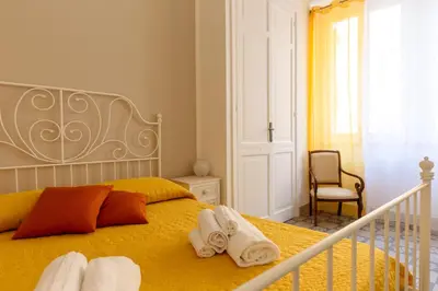 a bedroom with a bed with towels on it at Il Tarì Apartment in Palermo
