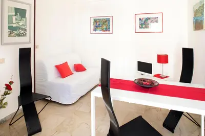 a white room with a white bed and a desk at Suite Vera in Palermo
