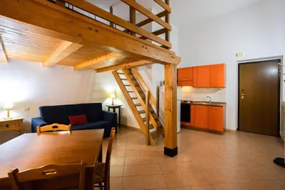 a living room with a couch and a table and a kitchen at Hola Cathedral House in Palermo