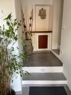 a hallway with potted plants in a room at Hola Cathedral House in Palermo