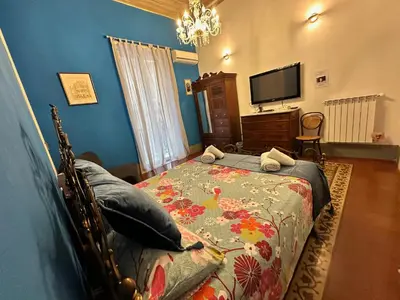 a hallway with a desk and a painting on the wall at Medusa in Palermo