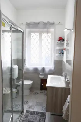 a bathroom with a shower and a sink and a toilet at Sol&Luna 1909 in Palermo