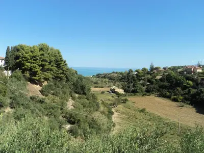 a view of a hill with the ocean in the background at Guidaloca Bay House con mini-piscina Scopello in Castellammare del Golfo