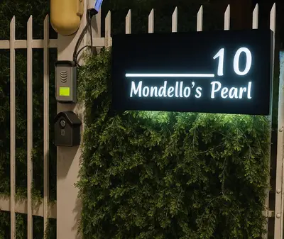 a sign for a mondulkiri park next to a bush at Mondello's Pearl in Mondello