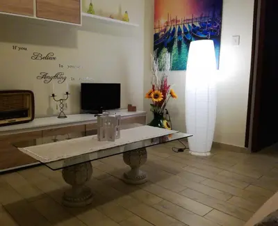 a living room with a table and a tv at Hello Cathedral House in Palermo
