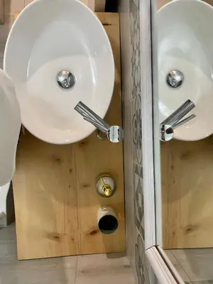 a bathroom with two sinks in a wooden cabinet at Apartament Home Lory in Palermo