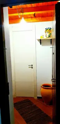 a bathroom with a white door and a toilet at Apartament Home Lory in Palermo