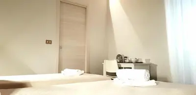 a room with two beds and a table in it at Apartament Home Lory in Palermo
