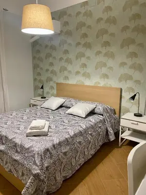 a bedroom with a bed with two pillows on it at Apartament Home Lory in Palermo